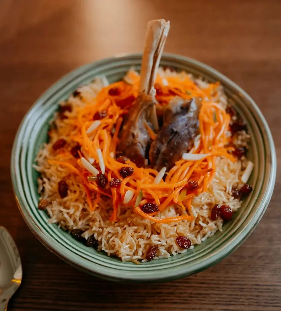 Qabli palaw with lamb shank in a green bowl
